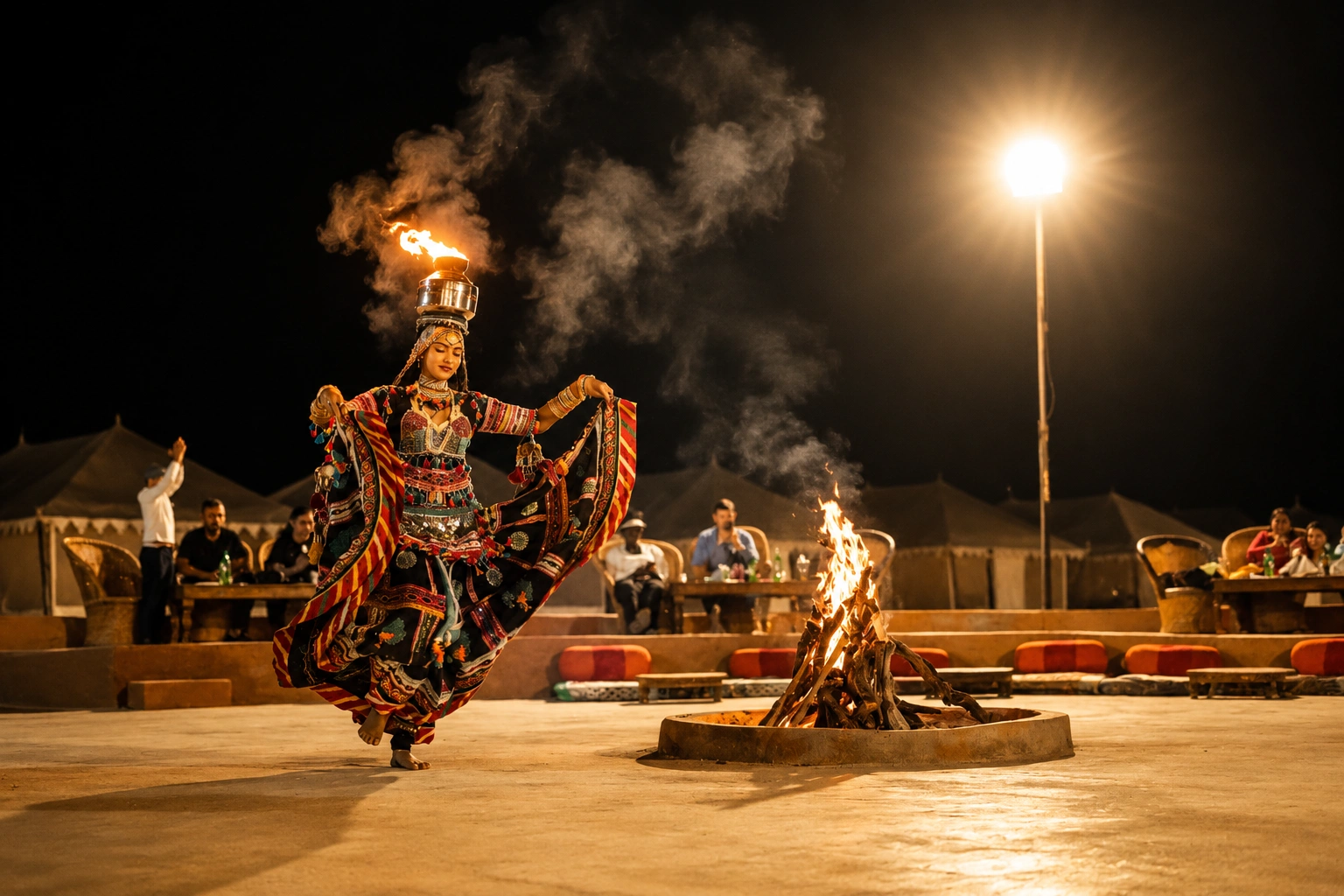 Kalbelia dancer performing with fire by the bonfire